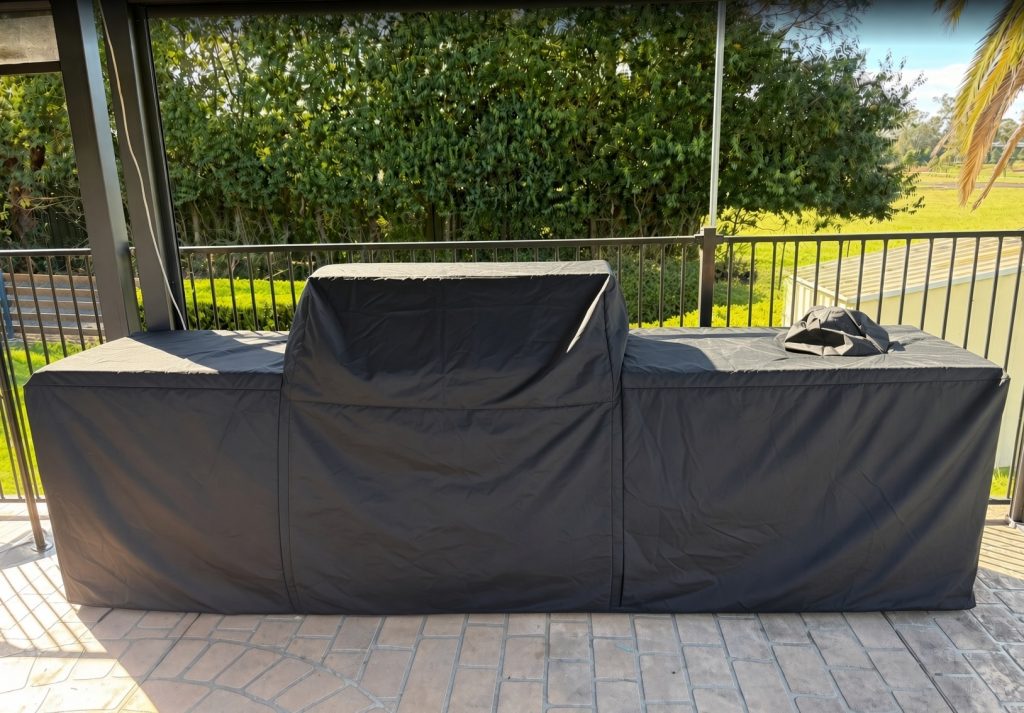 custom-grill-cover-canada.jpg Custom made grill cover in black fitted over a grill kitchen on a covered patio – The Cover Company Canada